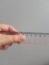 A hand is holding a plastic ruler Royalty Free Stock Photo