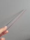 A hand is holding a plastic ruler Royalty Free Stock Photo