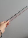 A hand is holding a plastic ruler Royalty Free Stock Photo