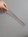 A hand is holding a plastic ruler Royalty Free Stock Photo
