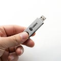 Hand holding a portable wireless usb adapter for network connectivity Royalty Free Stock Photo