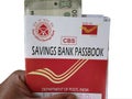 Hand holding post office saving passbook