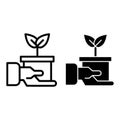 Hand holding pot with plant line and glyph icon. Sprout in pot vector illustration isolated on white. Flover pot in hand Royalty Free Stock Photo