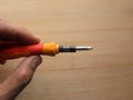 Hand holding precision screwdriver