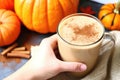 hand holding a pumpkin spice latte with sprinkles of nutmeg Royalty Free Stock Photo
