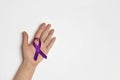 Hand holding Purple ribbons on a white background. World epilepsy day Royalty Free Stock Photo