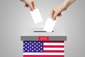 Hand holding and putting voting paper in ballot voting box with USA flag symbol. Royalty Free Stock Photo