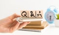 Hand holding Q and A word with wooden cube block. FAQ& x28; frequency asked questions& x29;, Answer, Question Ask, Information. Royalty Free Stock Photo