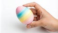 Hand holding a rainbow Easter egg. Use for Easter themes, spring celebrations Royalty Free Stock Photo
