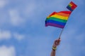 Hand holding rainbow gay flag, symbol of lgbt people, diversity of genders love. Lgbtq community pride month. Flag lgbt