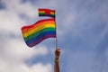 Hand holding rainbow gay flag, symbol of lgbt people, diversity of genders love. Lgbtq community pride month. Flag lgbt