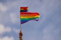 Hand holding rainbow gay flag, symbol of lgbt people, diversity of genders love. Lgbtq community pride month. Flag lgbt