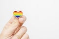 Hand holding rainbow gay pride symbol heart as lgbt rights concept, copy space Royalty Free Stock Photo