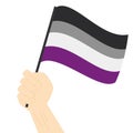 Hand holding and raising Asexual pride flag isolated on white background