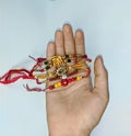 A hand holding Rakhi on hand on the event of rakshabandhan in India.