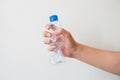 Hand holding a recyclable plastic bottles on white background