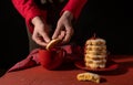 Hand holding red biscuit gift black background cup coffee tea Royalty Free Stock Photo