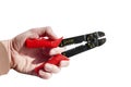 Hand holding red and black equipment plastic and metal cutter Royalty Free Stock Photo