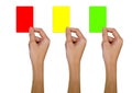 Hand holding a red card, a yellow card, a green card on a white background. Royalty Free Stock Photo