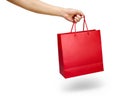 Hand holding a red color shopping bag isolated on white Royalty Free Stock Photo