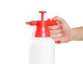 Hand holding red garden sprayer. Close up. Isolated on white background Royalty Free Stock Photo