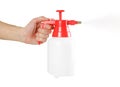 Hand holding red garden sprayer. Close up. Isolated on white background Royalty Free Stock Photo