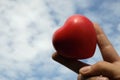 Hand holding red heart background by bluesky with cloud use as freedom , love and healthcare concept