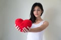 hand holding red heart.Happy beautiful young woman holding red cushion heart shape smiling and looking at camera.love Royalty Free Stock Photo