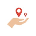 Hand holding red location markers