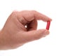 Hand holding red medical pill Royalty Free Stock Photo