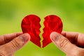 Hand holding red paper broken heart for divorce or reconcile Royalty Free Stock Photo