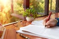 hand holding red pen over blurred paperwork for proofreading Royalty Free Stock Photo