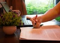 Hand holding red pen over blurred paperwork Royalty Free Stock Photo