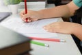 Hand holding red pen over proofreading paper Royalty Free Stock Photo