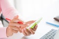 Hand holding red pencil and working with calculator, business document and laptop computer notebook Royalty Free Stock Photo