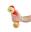 Hand holding red telephone receiver Royalty Free Stock Photo