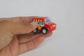 hand holding red toy car on white background Royalty Free Stock Photo