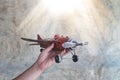 Hand holding red toy plane Royalty Free Stock Photo