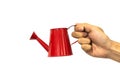 Hand holding red watering can isolated on white background clipping path included Royalty Free Stock Photo