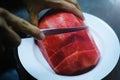 Hand holding red watermelon And use a knife to cutting watermelon in pieces to fruit plate Royalty Free Stock Photo