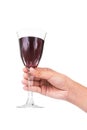 Hand holding red wine in crystal glass ready to toast Royalty Free Stock Photo