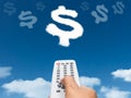 Hand holding remote control direct to dollar sign shape cloud Royalty Free Stock Photo