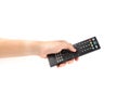 Hand holding a remote control isolated on a white background. Royalty Free Stock Photo
