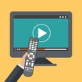 Hand holding remote control. TV icon concept. Play icon on television. Smart TV concept. Flat vector