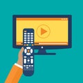 Hand holding remote control. TV icon concept. Play icon on television. Smart TV concept. Flat vector
