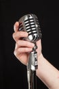 Hand holding a retro microphone Royalty Free Stock Photo