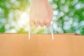 Hand holding reuse paper bag, on green Bokeh and bright yellow light background Royalty Free Stock Photo