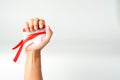 hand holding ribbon, red and white flag of Indonesia independence day August 17th, i love indonesia, on white background