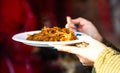 Hand holding a Romanian traditional dish at the winter Christmas market in Bucharest