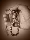 Hand holding rosary beads Royalty Free Stock Photo